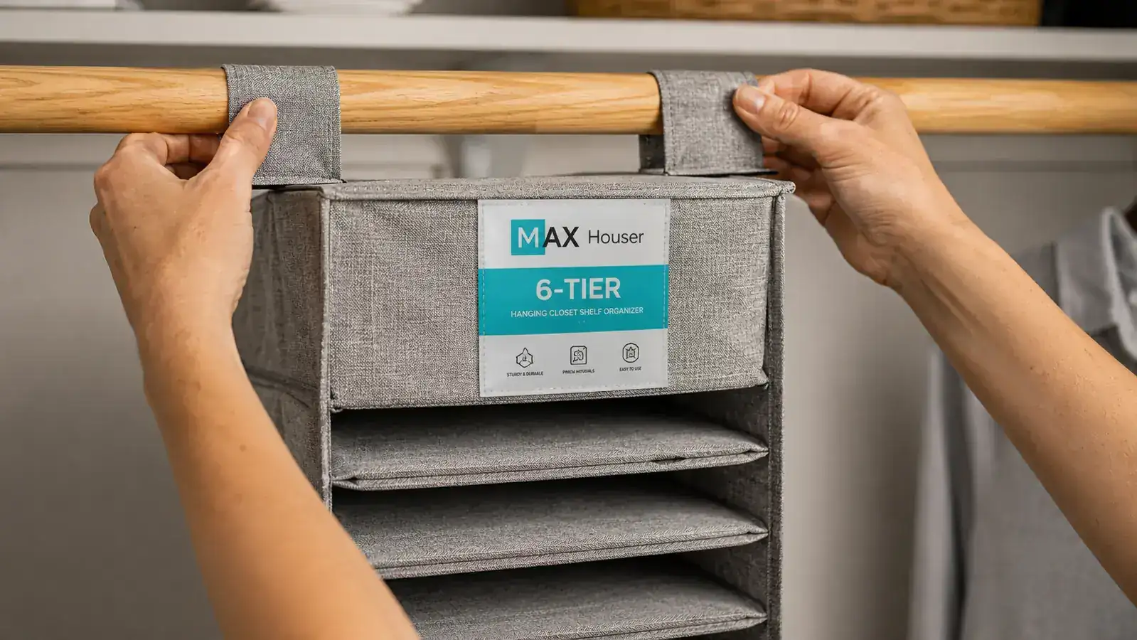 Hands clipping a hanging closet organizer over a wooden closet rod, showing the hook attachment