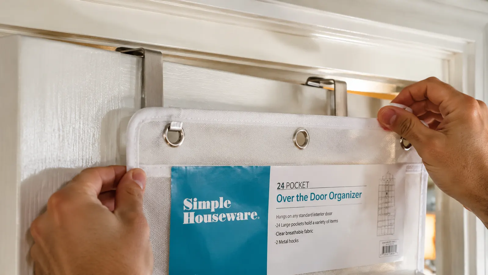 Close-up of the metal hook on the Simple Houseware organizer resting over a door frame, showing the clearance gap needed to close the door